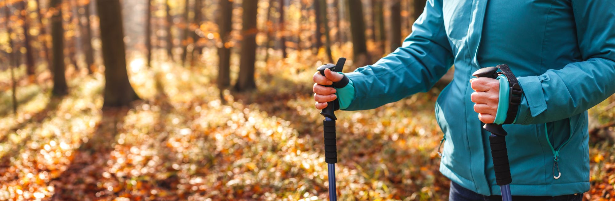 A woman hiking in a blue jacket